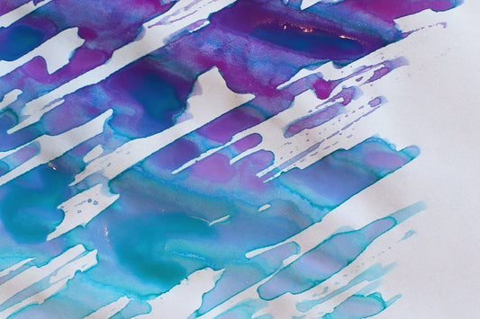 Dominant Industry alexandrite color changing calligraphy ink swatch and bottle on a map