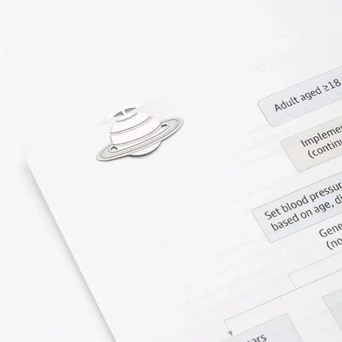 Space etching clip holding notebook pages showing functional use