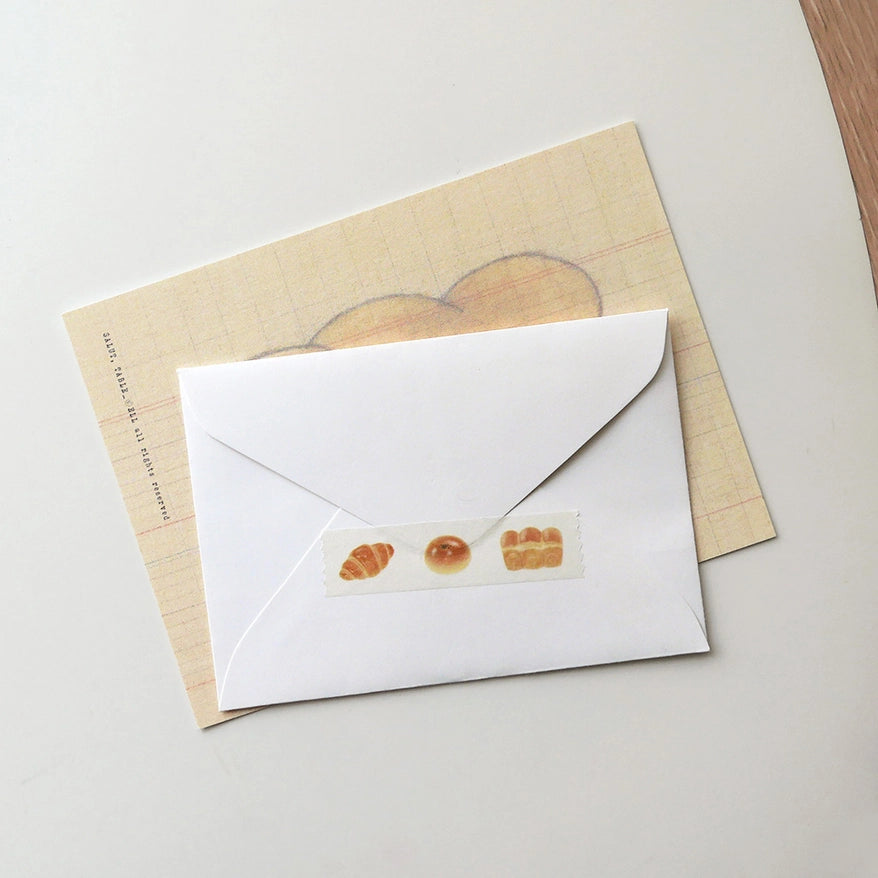 Suatelier bread washi tape used as envelope sealer decoration — South Korean illustrated masking tape styled shot