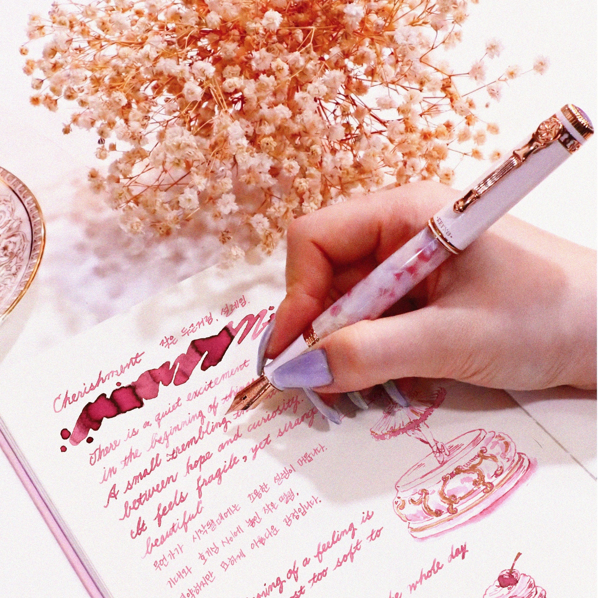 A hand writing with the Keyno.Stationery No.014 Cherishment fountain pen and no. 014 cherishment ink