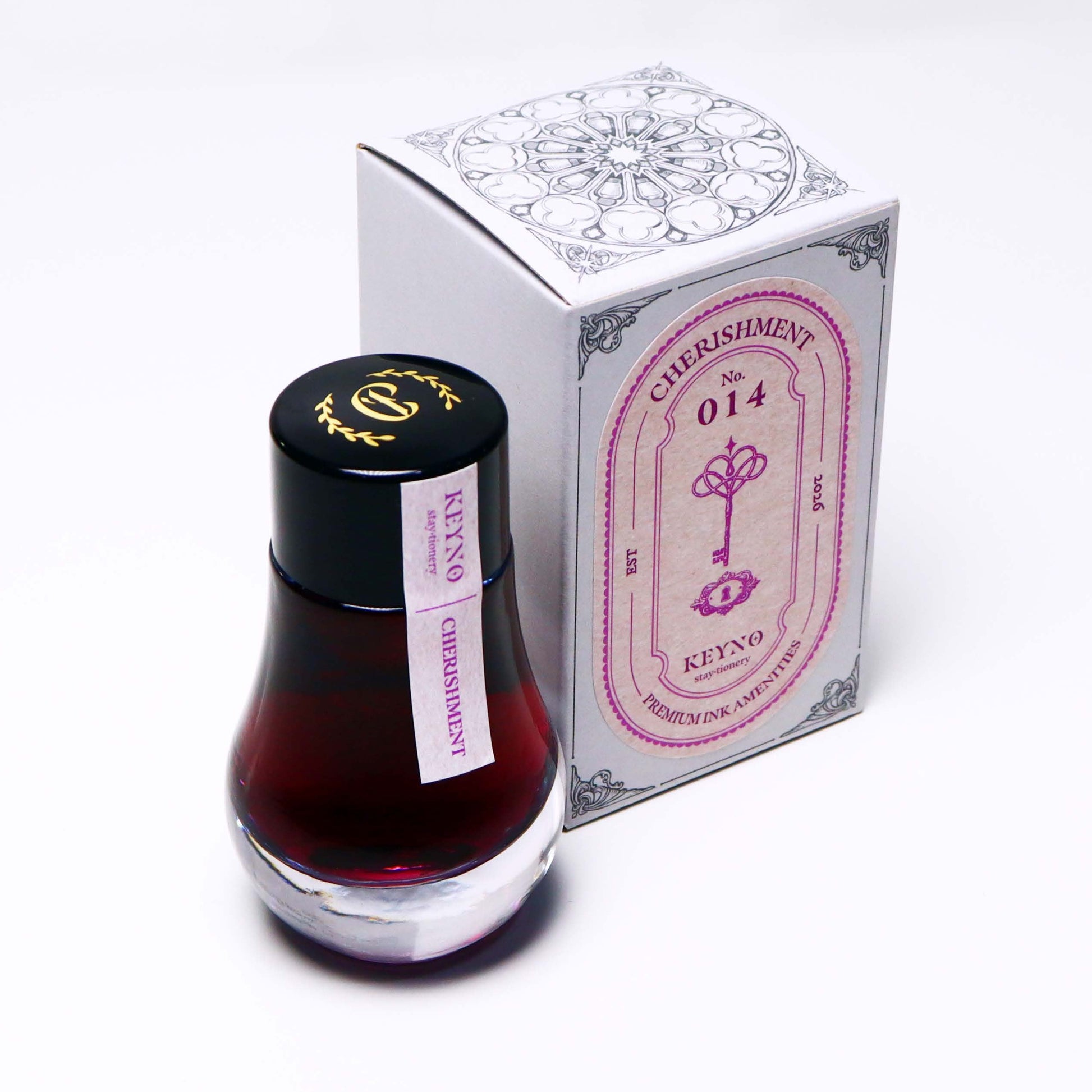 Dominant Industry Cherishment Key No. 14 fountain pen ink in a 25ml lightbulb-shaped glass bottle, muted dusty rose pink ink visible inside next to its box