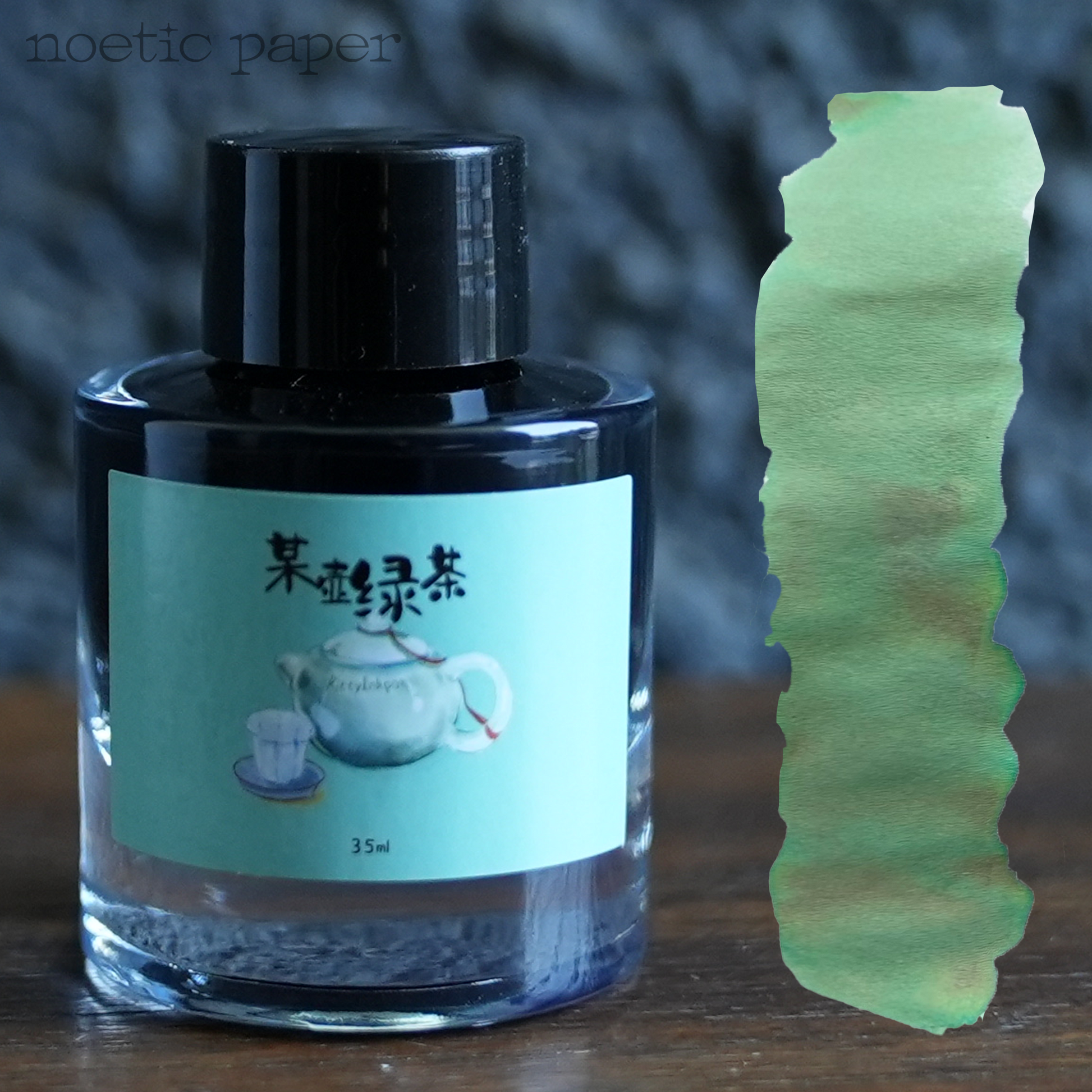 Kitty Inkpot A Certain green tea on a desk with a swatch next to it. 