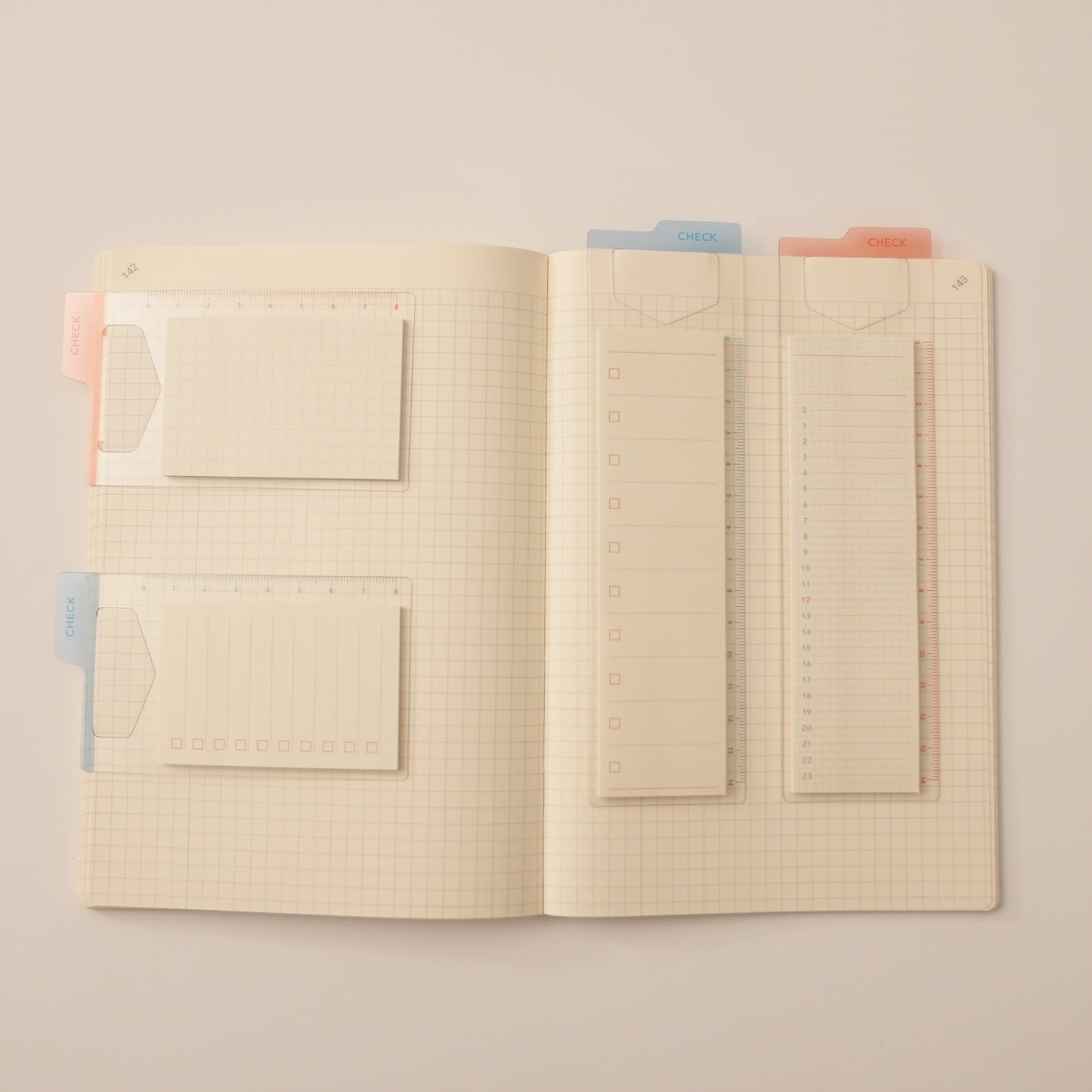 Isshoni. Bookmark Index Sticky Notes. One mounted on a blue ruler bookmark with a to-do list, the other mounted on a red ruler bookmark with a daily schedule and their mini counter parks in a daigo notebook