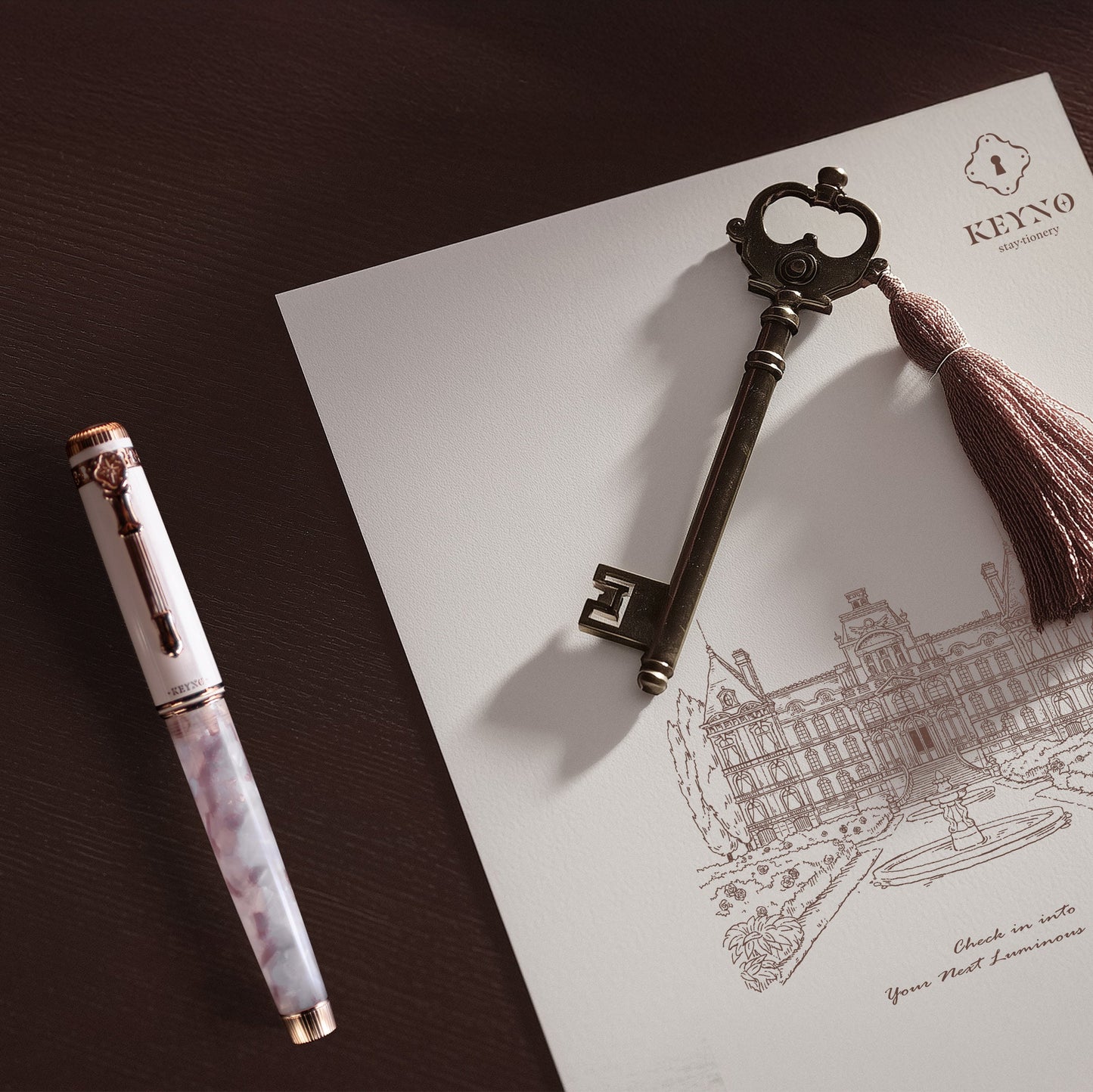 Keyno.Stationery No.14 Cherishment fountain pen on a themed background on a desk next to a key