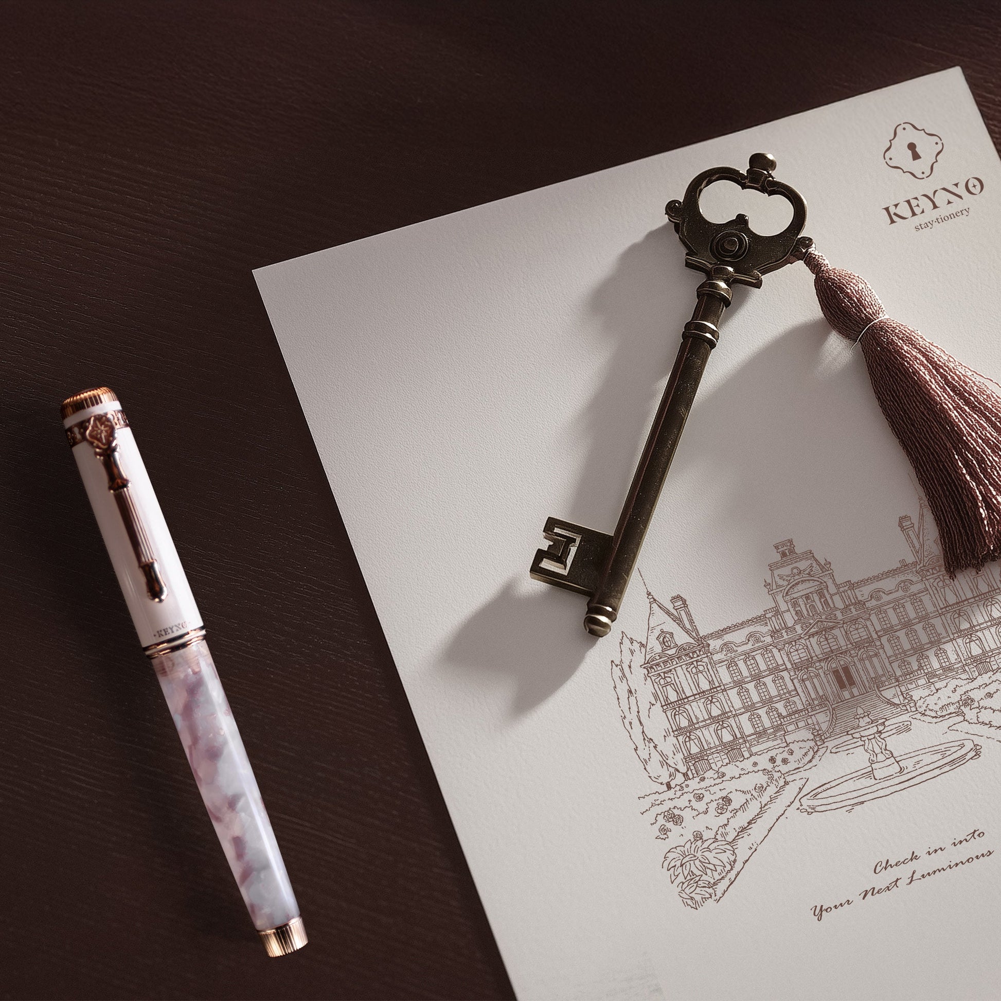 Keyno.Stationery No.14 Cherishment fountain pen on a themed background on a desk next to a key
