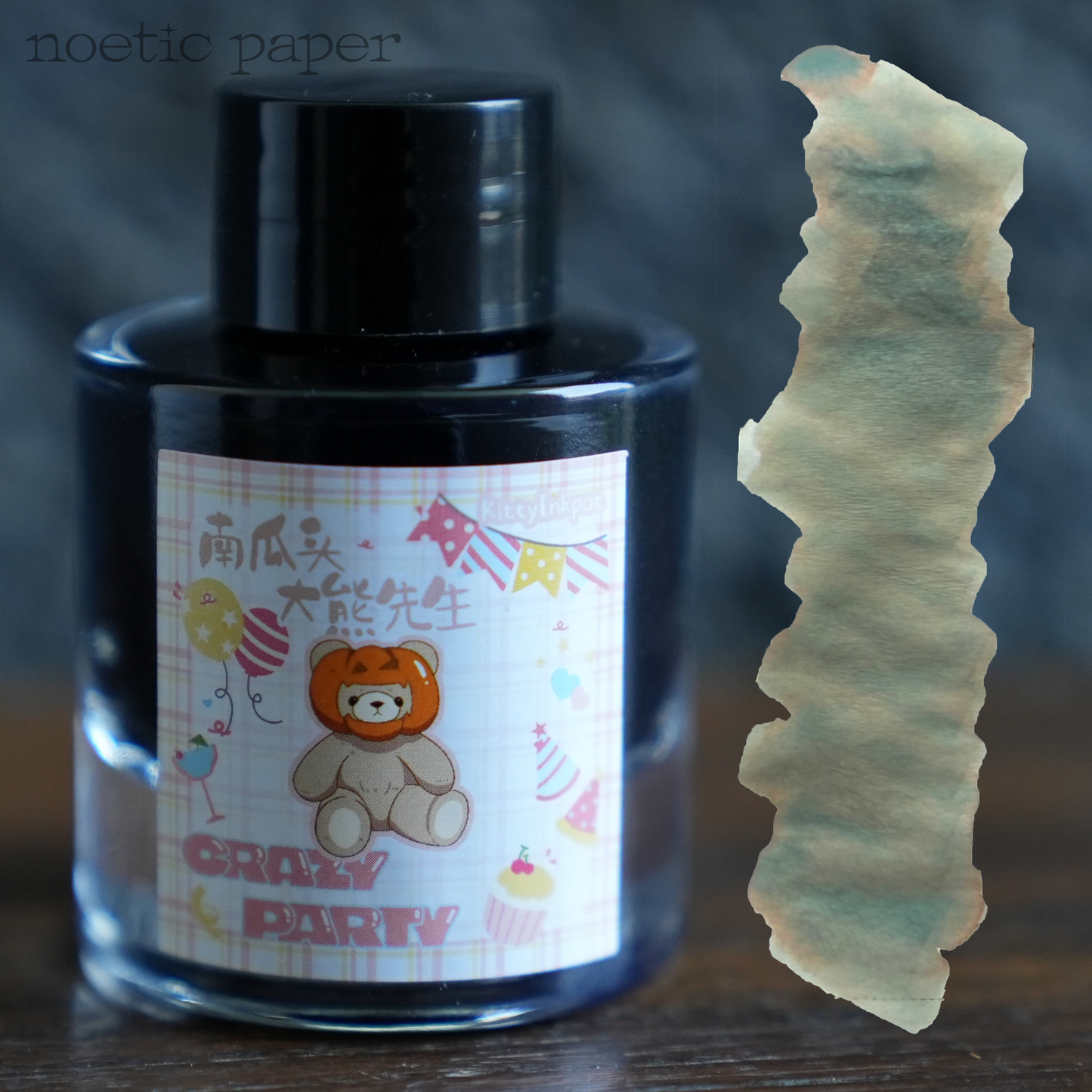 Kitty Inkpot Mr. Pumpkinhead Teddy on a desk with a swatch next to it. 