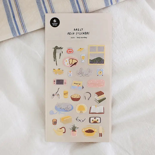 Suatelier No.1171 Lazy Sunday is a sticker sheet packed with everything you'd want from a lazy Sunday at home: eggs and toast, hanging plant, books, mushroom lamps, food, tea, candles, snacks, cats, movies, ipads, nintendo switches, rice, phone