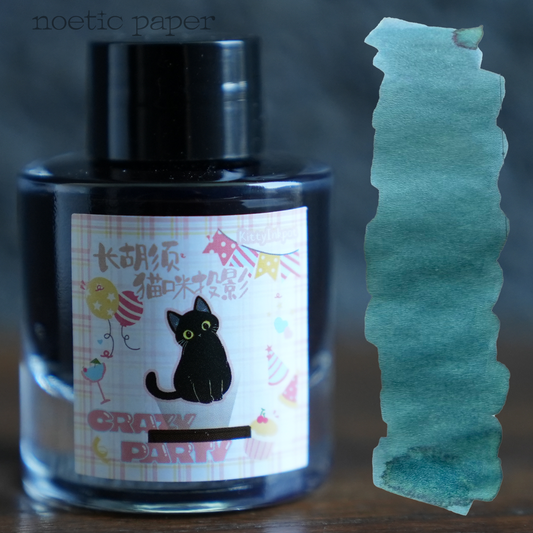 Kitty Inkpot long whiskered cat projection on a desk with a swatch next to it. 
